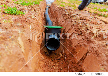 Laying underground drainage pipes for outflow of rainwater stormwater Laying underground drainage pipes for outflow of rainwater stormwater 112788082