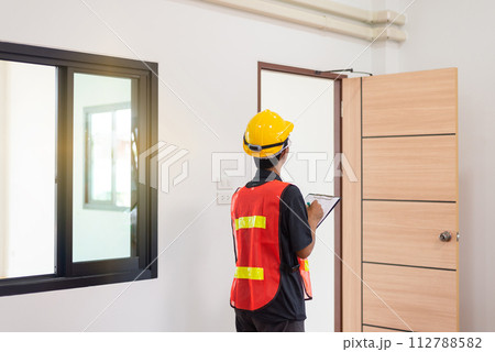 Men home Inspector surveyor wearing vests and hard hat at new property 112788582