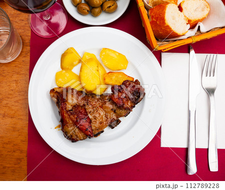 Honey glazed beef ribs with potato on table Honey glazed beef ribs with potato on table 112789228