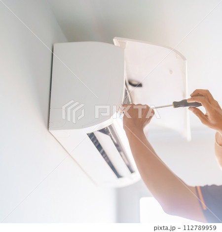 Man technician maintenance air conditioner. Purification system for cleaning dust PM2.5 and virus in home. Repair, Washing, Conditioning Service, Allergy, Pure air, health, Wellness and Air Pollution Man technician maintenance air conditioner. Purification system for cleaning dust PM2.5 and virus in home. Repair, Washing, Conditioning Service, Allergy, Pure air, health, Wellness and Air Pollution 112789959