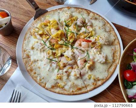 a pizza topped with seafood 112790663