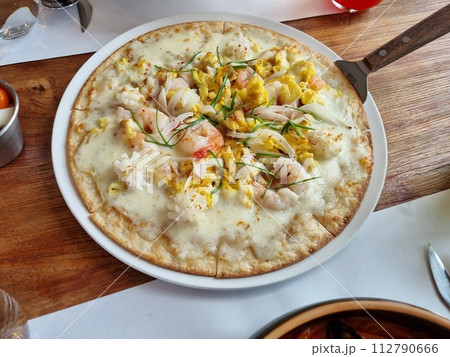 a pizza topped with seafood 112790666