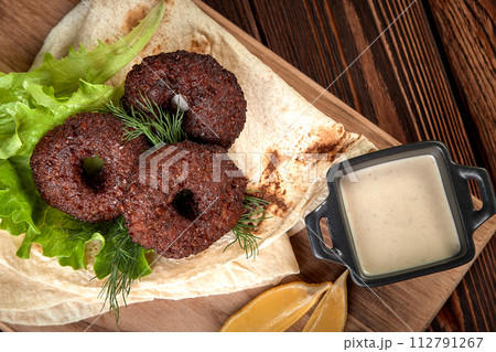 Tortilla wrap with falafel and fresh salad. Vegan tacos. Vegetarian healthy food. 112791267