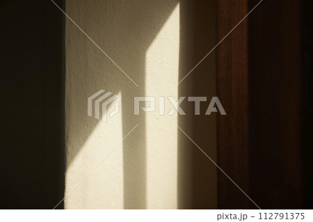 Comfortable rest by the sunny window. A background with sunlight and shadows that can be used in various designs. 112791375