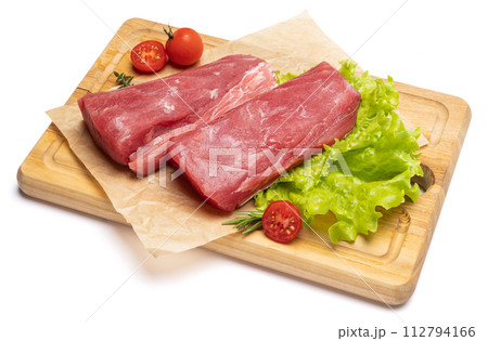 Fresh tuna Fish steak on a wooden cutting serving board isolated on a white background 112794166