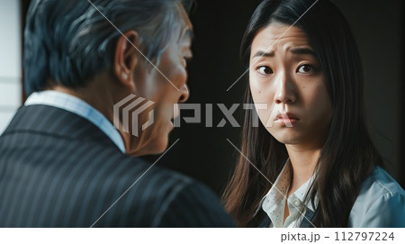 Concerned young employee listening to senior manager 112797224