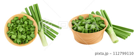 Green onion in wooden bowl isolated on the white background. Top view. Flat lay. Green onion in wooden bowl isolated on the white background. Top view. Flat lay. 112799110
