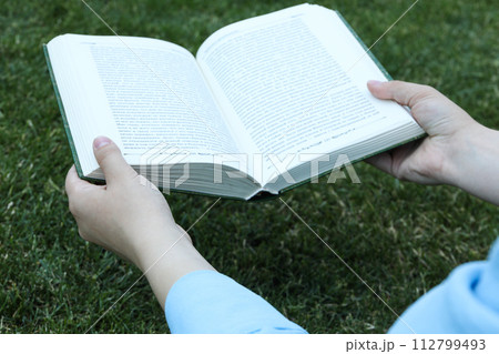 Books on the grass in the park 112799493