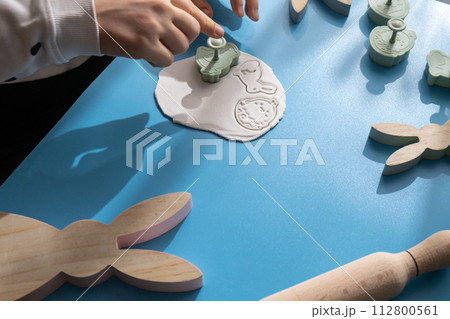 Workshop cutting figures Children air dry clay activity handicraft idea. DIY process step by step instruction. Preparing for Easter holiday decorating. Modern organic design minimalistic plastic free 112800561