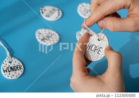 Master class word HOPE on EASTER clay egg Unrecognizable artist do it yourself air dry clay crafts for Easter holiday. Decoration gift idea Handmade children craft. Step by step instruction of Master class word HOPE on EASTER clay egg Unrecognizable artist do it yourself air dry clay crafts for Easter holiday. Decoration gift idea Handmade children craft. Step by step instruction of 112800880