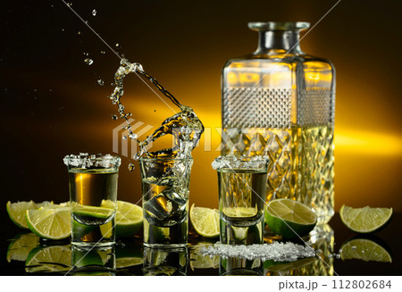 Gold tequila with sea salt and lime slices. 112802684