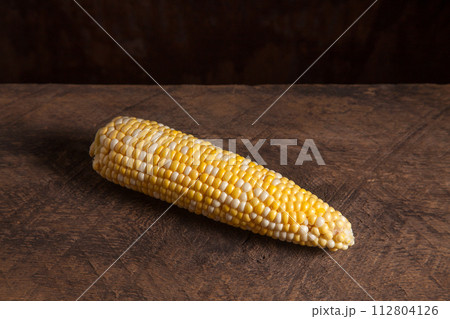 Cob sweet corn on wooden background.. 112804126