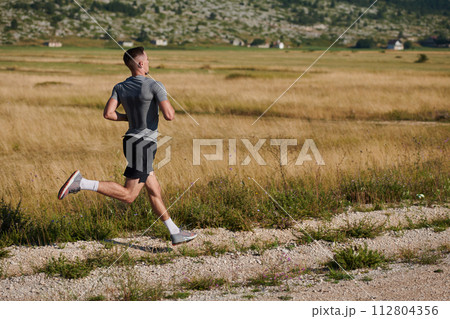 Determined Stride: Athletic Man Embarks on Marathon Preparation with Resolve. Determined Stride: Athletic Man Embarks on Marathon Preparation with Resolve. 112804356