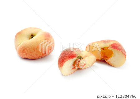 Whole and half of saturn peach or flat peaches isolated on white background with clipping path.. Whole and half of saturn peach or flat peaches isolated on white background with clipping path.. 112804766