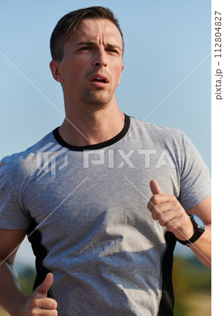 A dedicated marathon runner pushes himself to the limit in training. 112804827