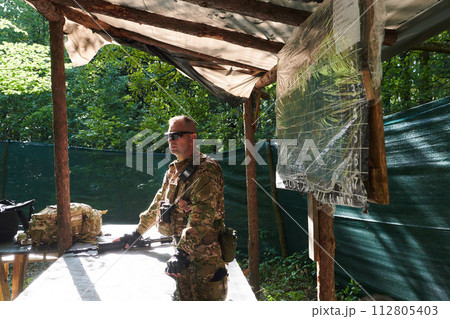 The esteemed leader of an elite military unit, strategic brilliance unfolds as he meticulously devises tactical plans for the upcoming military operation, surrounded by cutting-edge technology and a 112805403