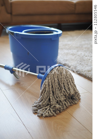 cleaning tiles floor with mop  112805546