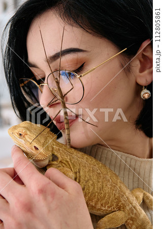 Woamn and Her Pets: A Bearded Dragon and a Stick Insect 112805861