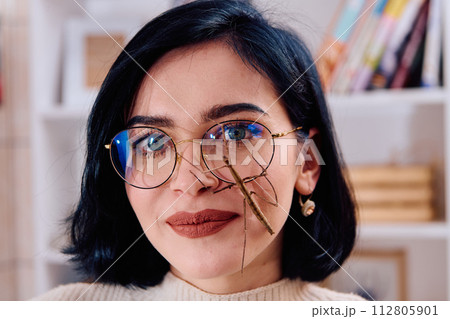 Young Woman Captured in a Beautiful Moment with Her Stick Insect (Medauroidea Extradentata) 112805901