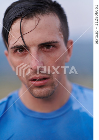 Post-Run Repose: Sweaty Athlete Rests After Intense Daily Run. 112806061