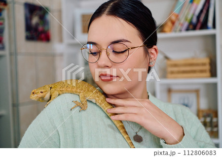 Beautiful Woman Posing with Her Adorable Bearded Dragon Pets Beautiful Woman Posing with Her Adorable Bearded Dragon Pets 112806083
