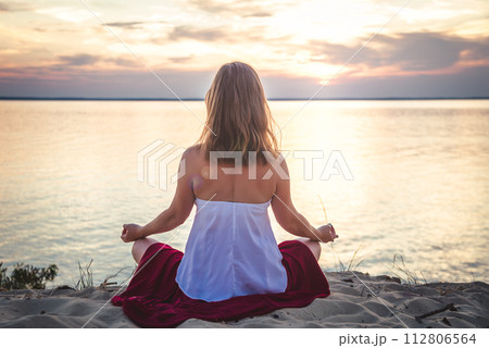 Woman meditating at the sea Woman meditating at the sea 112806564