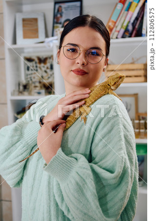 Beautiful Woman Posing with Her Adorable Bearded Dragon Pets Beautiful Woman Posing with Her Adorable Bearded Dragon Pets 112806575