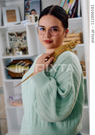 Beautiful Woman Posing with Her Adorable Bearded Dragon Pets 112806591