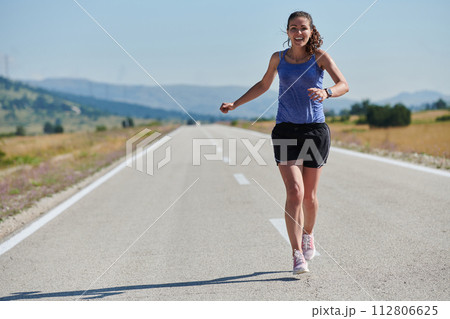 A determined woman athlete trains for success in the morning sun. 112806625