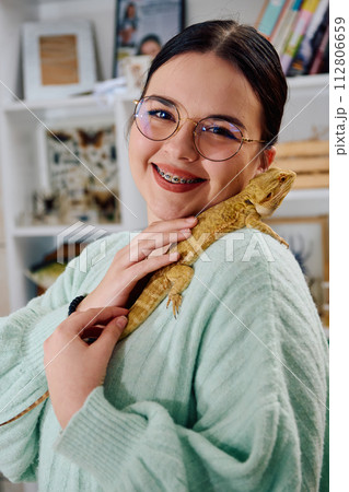 Beautiful Woman Posing with Her Adorable Bearded Dragon Pets Beautiful Woman Posing with Her Adorable Bearded Dragon Pets 112806659