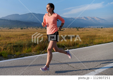 Determined Dawn: Confident and Motivated Athlete Embarks on Sunrise Run. Determined Dawn: Confident and Motivated Athlete Embarks on Sunrise Run. 112807251