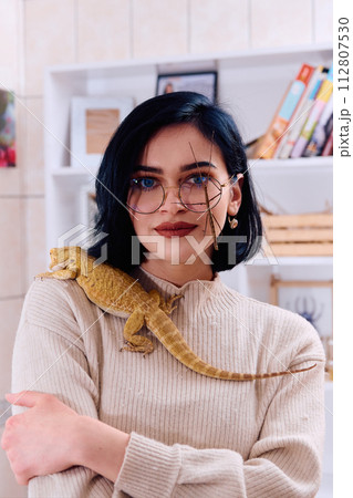 Woamn and Her Pets: A Bearded Dragon and a Stick Insect 112807530