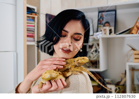 Beautiful Woman Posing with Her Two Adorable Bearded Dragon Pets Beautiful Woman Posing with Her Two Adorable Bearded Dragon Pets 112807630