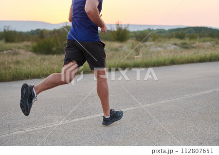 A dedicated marathon runner pushes himself to the limit in training. A dedicated marathon runner pushes himself to the limit in training. 112807651