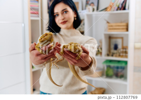 Beautiful Woman Posing with Her Two Adorable Bearded Dragon Pets Beautiful Woman Posing with Her Two Adorable Bearded Dragon Pets 112807769