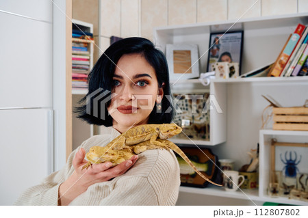 Beautiful Woman Posing with Her Two Adorable Bearded Dragon Pets Beautiful Woman Posing with Her Two Adorable Bearded Dragon Pets 112807802