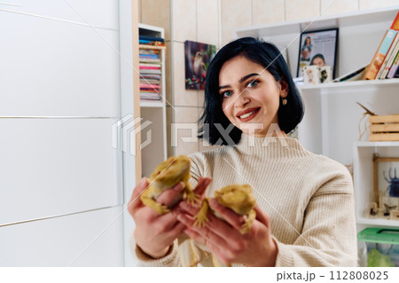 Beautiful Woman Posing with Her Two Adorable Bearded Dragon Pets 112808025