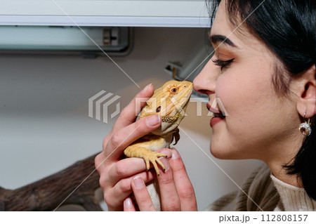 Beautiful Woman Kissing Bearded Dragon Pets 112808157
