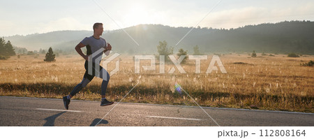 Determined Stride: Athletic Man Embarks on Marathon Preparation with Resolve. 112808164
