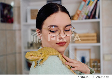 Beautiful Woman Posing with Her Adorable Bearded Dragon Pets Beautiful Woman Posing with Her Adorable Bearded Dragon Pets 112808436
