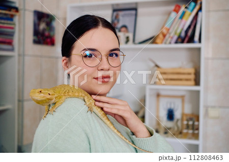 Beautiful Woman Posing with Her Adorable Bearded Dragon Pets Beautiful Woman Posing with Her Adorable Bearded Dragon Pets 112808463