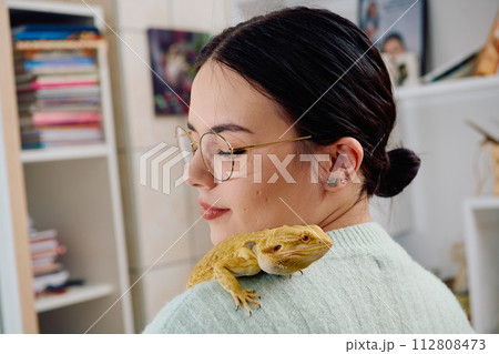 Beautiful Woman Posing with Her Adorable Bearded Dragon Pets Beautiful Woman Posing with Her Adorable Bearded Dragon Pets 112808473