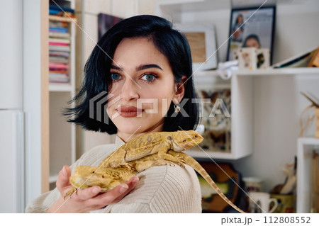 Beautiful Woman Posing with Her Two Adorable Bearded Dragon Pets Beautiful Woman Posing with Her Two Adorable Bearded Dragon Pets 112808552