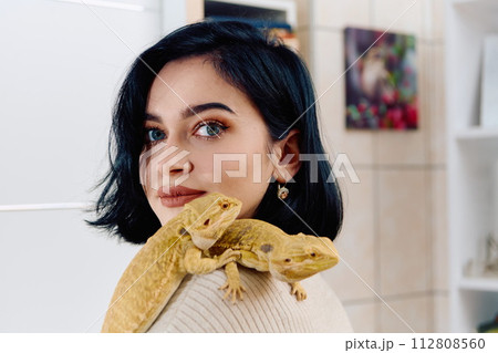 Beautiful Woman Posing with Her Two Adorable Bearded Dragon Pets 112808560