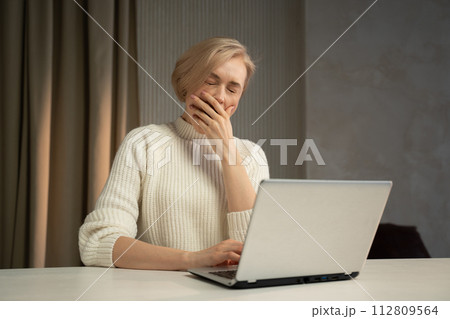 Overwhelmed Office Worker Taking a Break at Her Desk During a Stressful Day Overwhelmed Office Worker Taking a Break at Her Desk During a Stressful Day 112809564