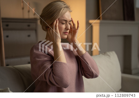 Woman Experiencing a Headache at Home During Evening Hours 112809743