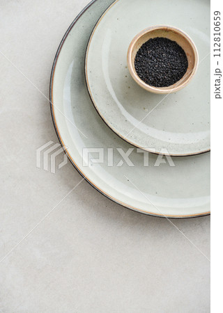 Two plates of different sizes and tiny bowl 112810659