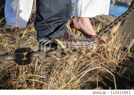 Steps Together A Couples Feet Clad in Formal Shoes on Rustic Ground 112811661