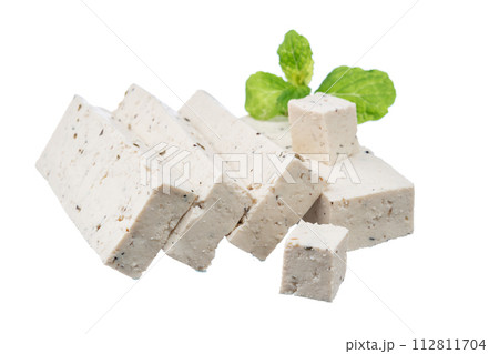 A pile of diced sea tofu cheese isolated on a white background vegan healthy eating. Sea tofu with algae with mint leaves. A pile of diced sea tofu cheese isolated on a white background vegan healthy eating. Sea tofu with algae with mint leaves. 112811704