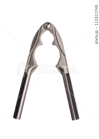 Metal nut cracker tongs for opening nuts isolated on white background. Close-up. 112811740